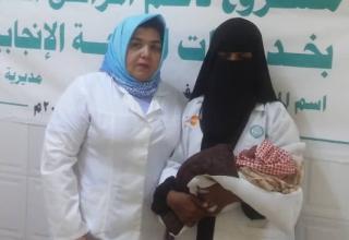 Midwives hold Amani's baby at the hospital where Amani's life was saved. © UNFPA Yemen