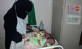 A midwife cares for Mohsina's unexpected twins at Jardan Hospital. ©FMF
