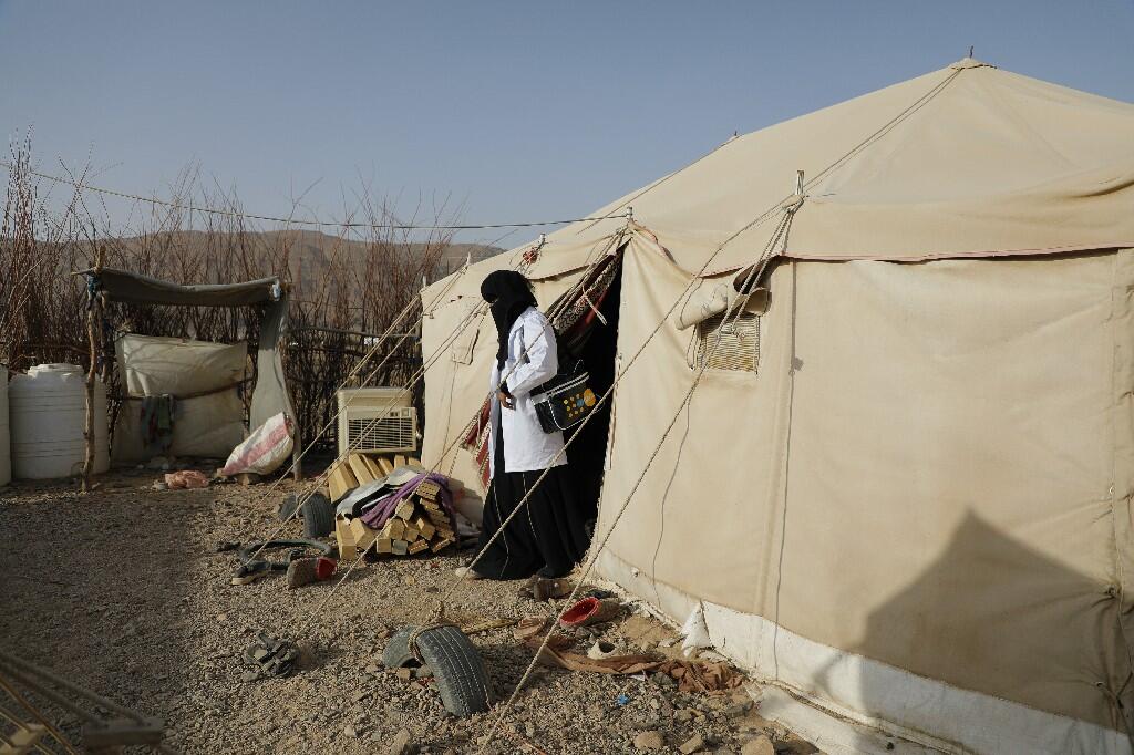 A reproductive health worker exits a tent in a displacement camp where she is providing services. UNFPA is the sole provider of life-saving reproductive health services in Yemen. © UNFPA Yemen